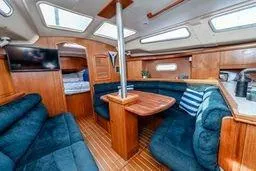 Slide: The Image of Interior of 2003 Hunter 356 sailboat with cozy seating and wooden finishes. - 23