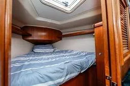 Slide: The Image of Cozy cabin interior of 2003 Hunter 356 sailboat with wooden finish and skylight. - 24
