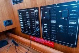 Slide: The Image of Control panel of a 2003 Hunter 356 sailboat with switches and dials. - 25