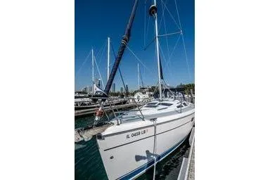Slide: The Image of 2003 Hunter 356 sailboat docked at marina under clear blue sky. - 4