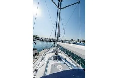 Slide: The Image of 2003 Hunter 356 sailboat deck view at marina under clear sky. - 5