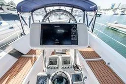 Slide: The Image of Cockpit view of 2003 Hunter 356 sailboat with navigation instruments and wooden deck. - 7