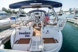 Slide: The Image of 2003 Hunter 356 sailboat docked, featuring "Pharma Sea" name and American flag. - 8