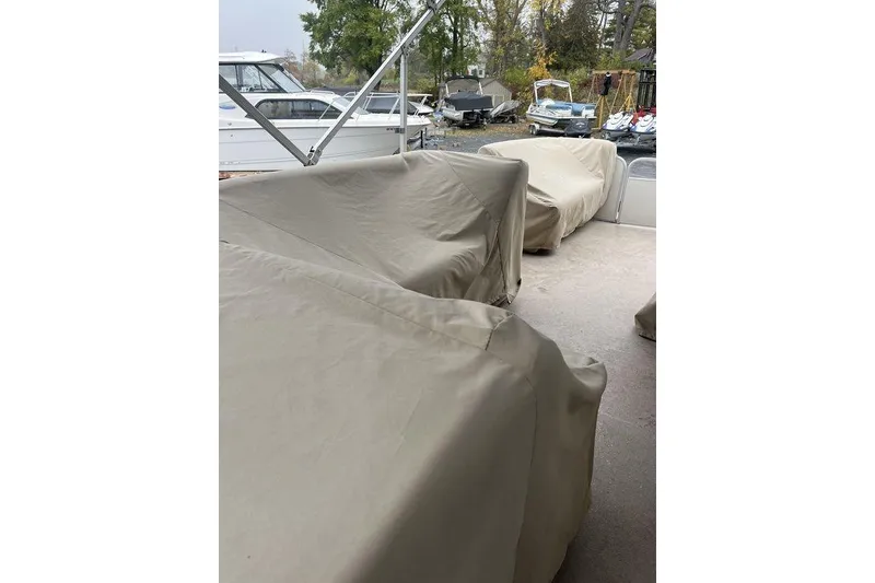 Slide: The Image of Covered seating on a 2016 Godfrey 2086 boat, parked outdoors. - 10