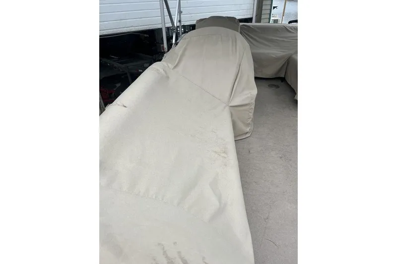 Slide: The Image of Covered Godfrey 2086 boat, 2016 model, under a shelter with protective fabric. - 11