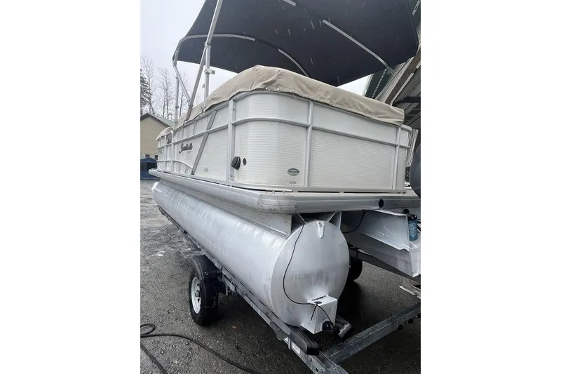 Slide: The Image of 2016 Godfrey 2086 pontoon boat with canopy on trailer, parked outdoors. - 15