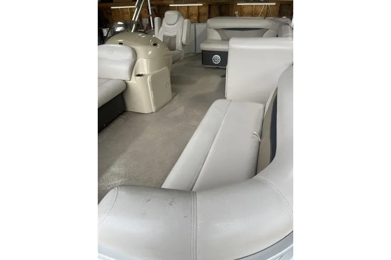 Slide: The Image of 2016 Godfrey 2086 boat interior with beige seating and steering console. - 16