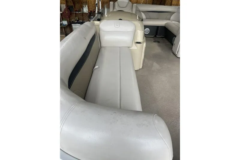 Slide: The Image of 2016 Godfrey 2086 boat interior with beige seating and carpeted floor. - 17
