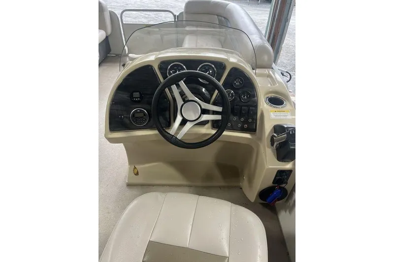Slide: The Image of Steering console of a 2016 Godfrey 2086 boat with gauges and controls. - 22