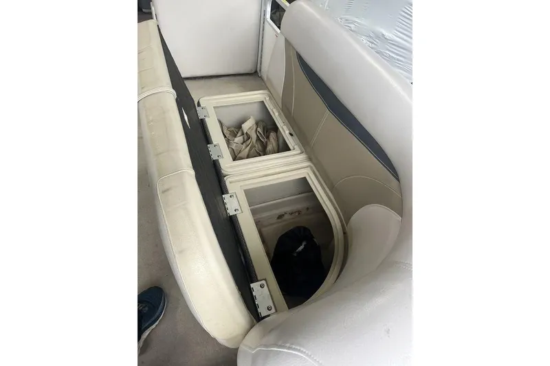 Slide: The Image of 2016 Godfrey 2086 boat interior with open storage compartments under seats. - 23