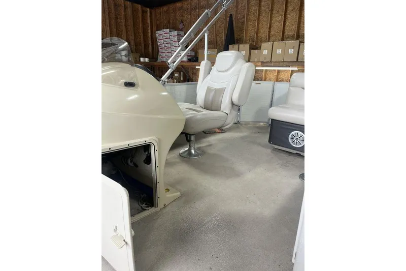 Slide: The Image of Interior of a 2016 Godfrey 2086 boat with beige seating and storage compartments. - 25