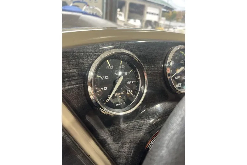 Slide: The Image of Close-up of a 2016 Godfrey 2086 speedometer and tachometer on a boat dashboard. - 26