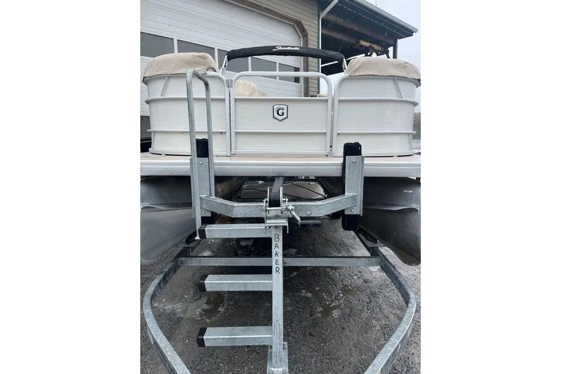 Slide: The Image of 2016 Godfrey 2086 pontoon boat on trailer, parked near a building. - 3