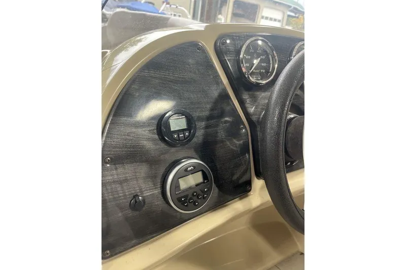 Slide: The Image of Dashboard of a 2016 Godfrey 2086 boat with gauges and controls. - 30