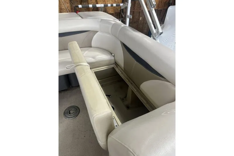 Slide: The Image of Open storage compartment in 2016 Godfrey 2086 boat with beige seating. - 32