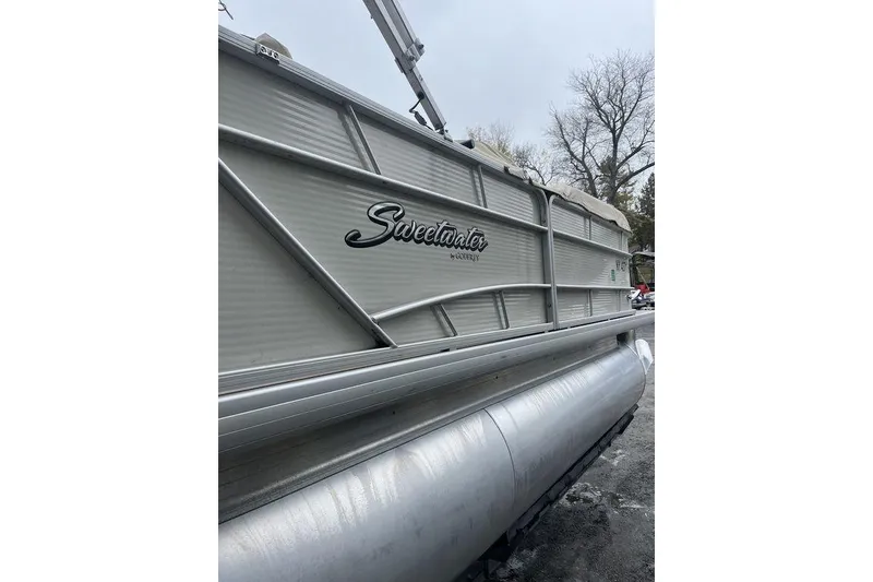 Slide: The Image of 2016 Godfrey Sweetwater 2086 pontoon boat, side view with logo, overcast sky. - 5