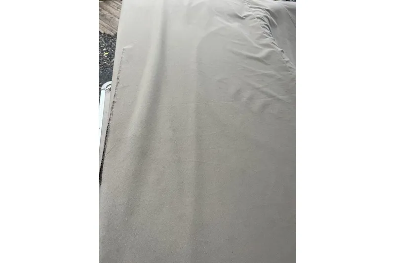 Slide: The Image of Gray fabric cover on a 2016 Godfrey 2086 boat, showing texture and creases. - 9