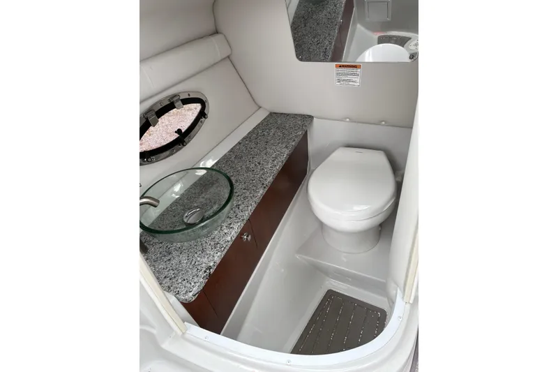 Slide: The Image of 2022 Crownline Eclipse E285 XS boat bathroom with modern sink and toilet. - 10
