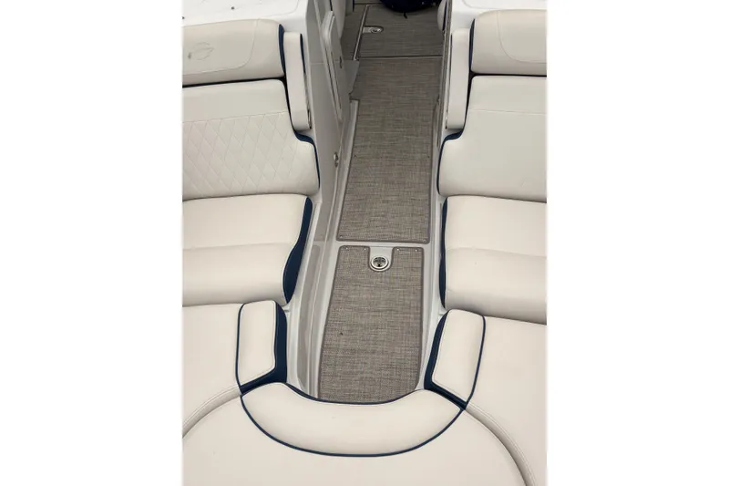 Slide: The Image of 2022 Crownline Eclipse E285 XS boat interior with beige seating and gray flooring. - 11