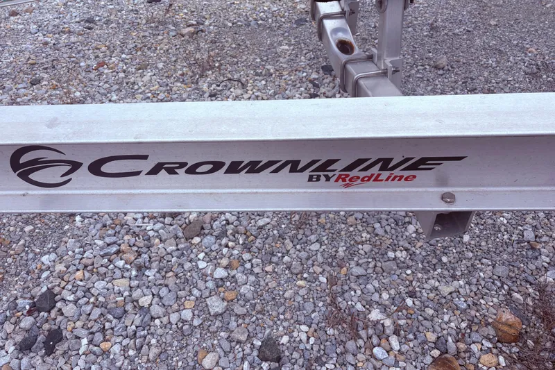 Slide: The Image of Crownline Eclipse E285 XS 2022 trailer on gravel surface. - 13