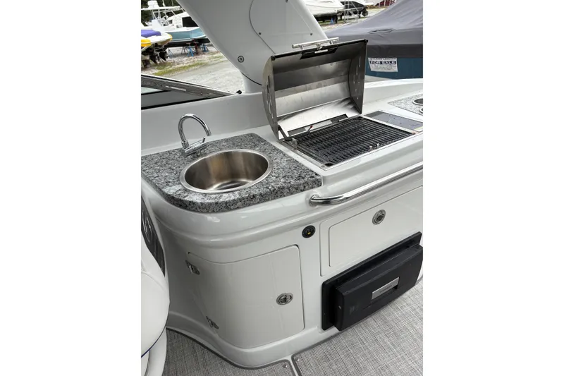 Slide: The Image of 2022 Crownline Eclipse E285 XS boat kitchen with sink and grill. - 5