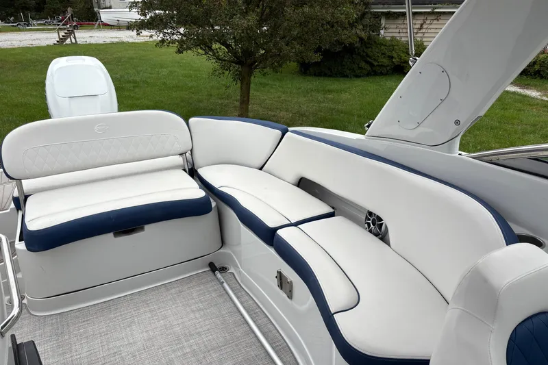 Slide: The Image of 2022 Crownline Eclipse E285 XS boat interior with white and blue seating. - 6