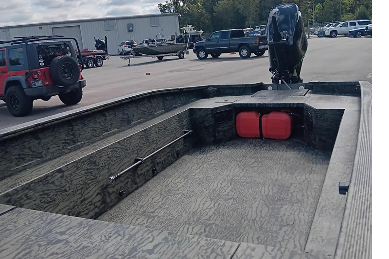 Slide: The Image of 2026 Tracker Grizzly 1650 T Prairie Wings Edition boat in parking lot with vehicles. - 10