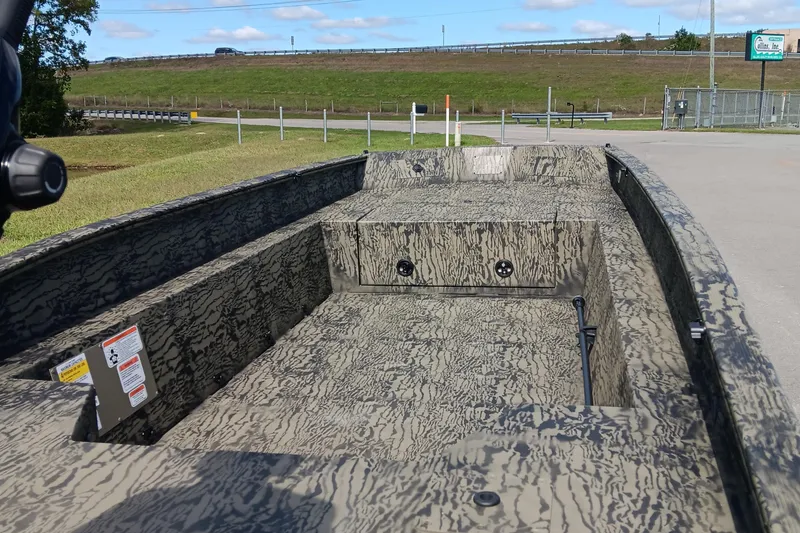 Slide: The Image of 2026 Tracker Grizzly 1650 T Prairie Wings Edition boat with camouflage interior design. - 11