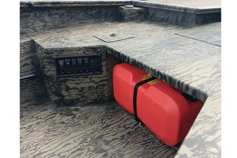 Slide: The Image of 2026 Tracker Grizzly 1650 T Prairie Wings Edition boat interior with camo design and red fuel tank. - 13