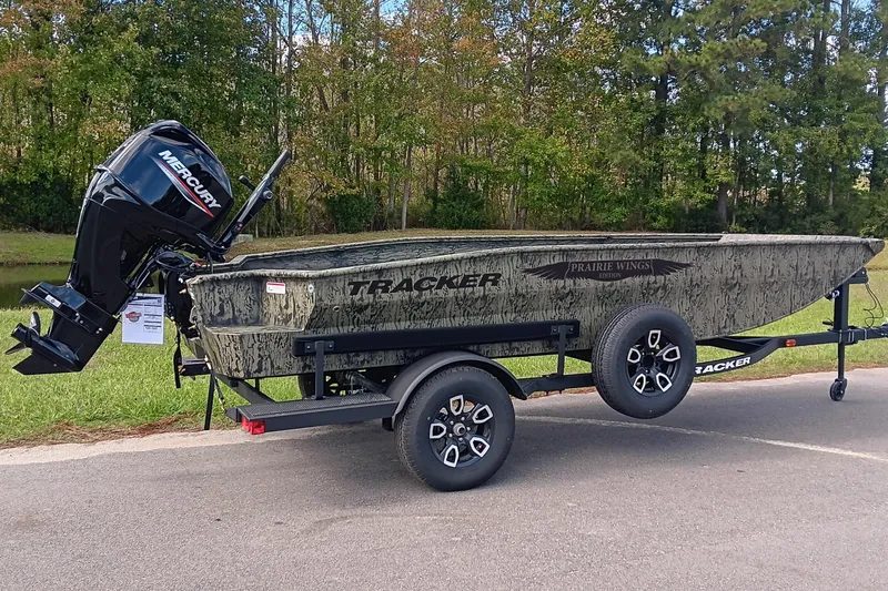 Slide: The Image of 2026 Tracker Grizzly 1650 T Prairie Wings Edition boat on trailer, outdoors. - 2