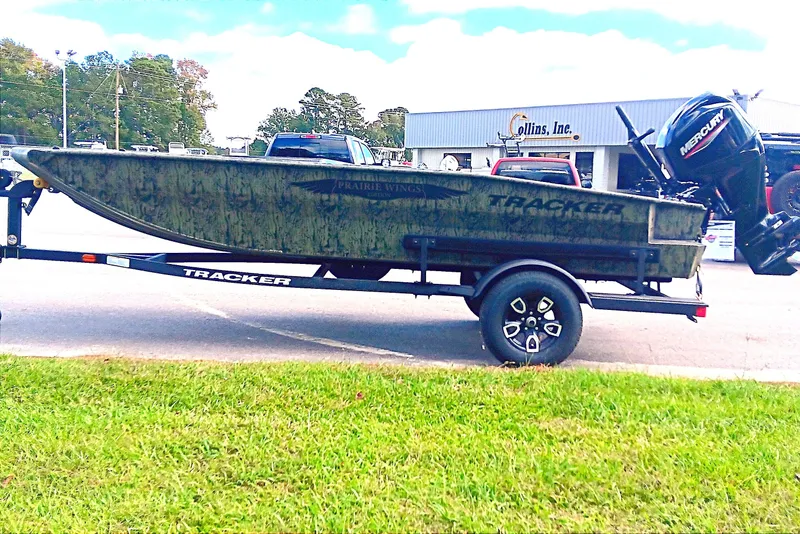 Slide: The Image of 2026 Tracker Grizzly 1650 T Prairie Wings Edition boat on trailer, parked outdoors. - 5