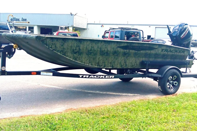 Slide: The Image of 2026 Tracker Grizzly 1650 T Prairie Wings Edition boat on trailer, parked outdoors. - 6