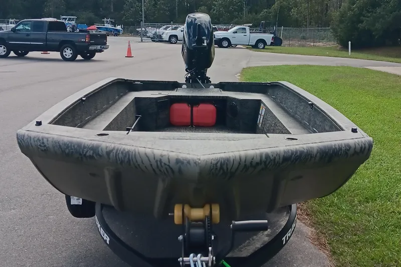 Slide: The Image of 2026 Tracker Grizzly 1650 T Prairie Wings Edition boat on trailer, parked outdoors. - 7