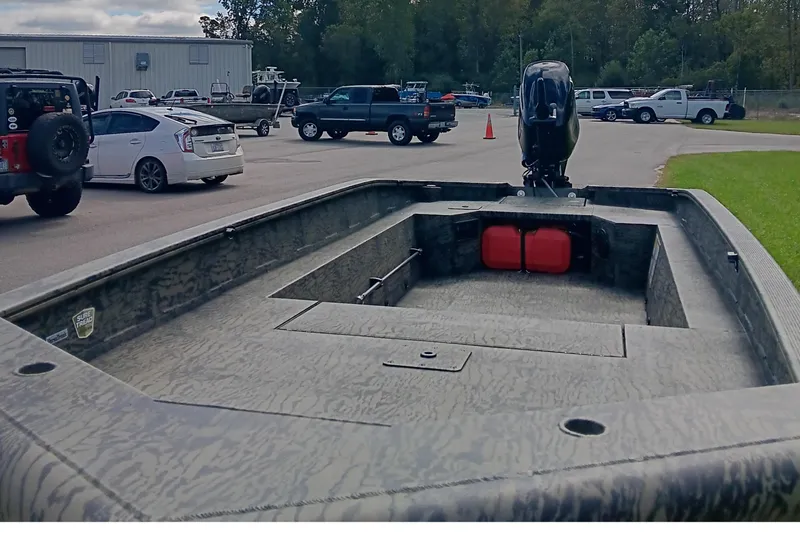 Slide: The Image of 2026 Tracker Grizzly 1650 T Prairie Wings Edition boat in parking lot. - 9