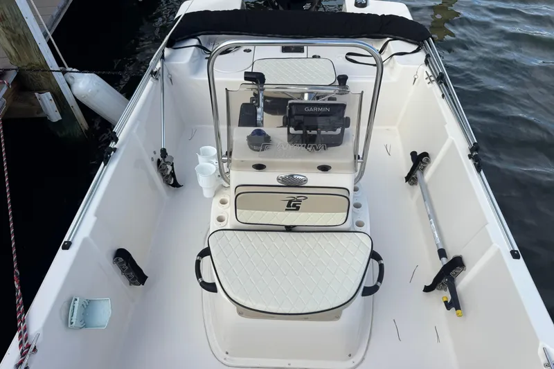 Slide: The Image of 2023 Carolina Skiff 16 JVX CC boat interior with Garmin equipment, docked by water. - 10