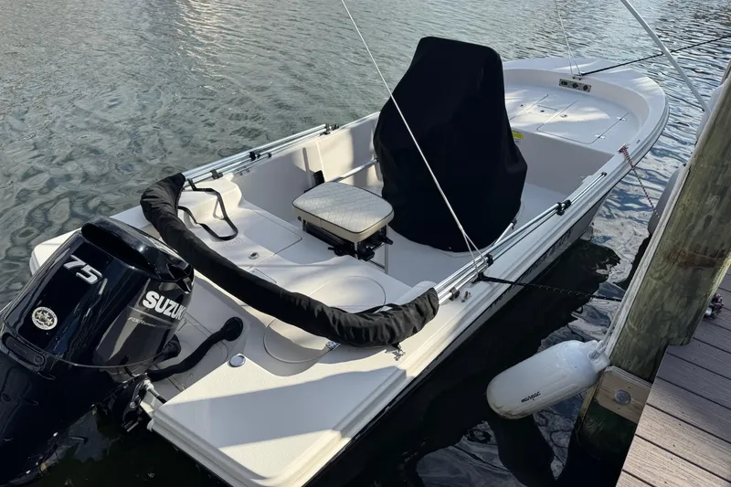 Slide: The Image of 2023 Carolina Skiff 16 JVX CC boat docked with Suzuki 75 outboard motor. - 4
