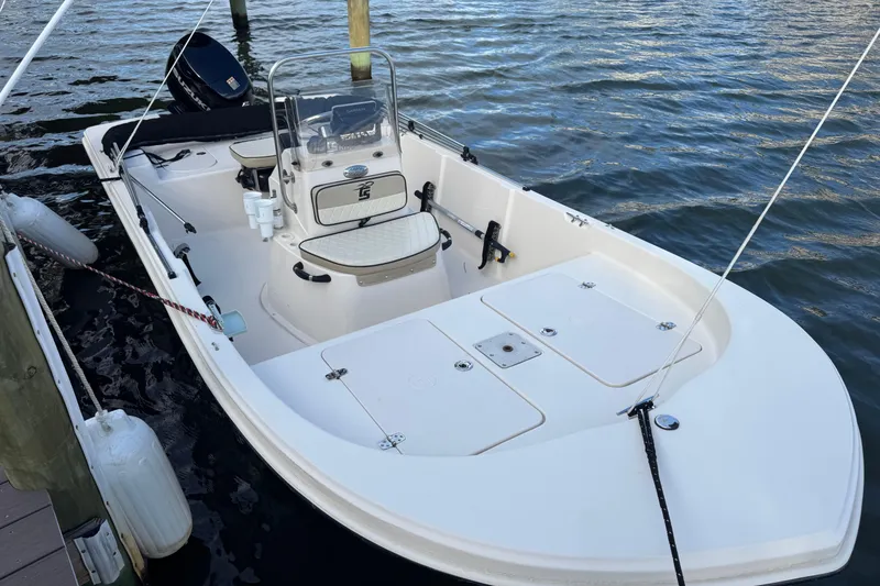 Slide: The Image of 2023 Carolina Skiff 16 JVX CC boat docked on calm water. - 5