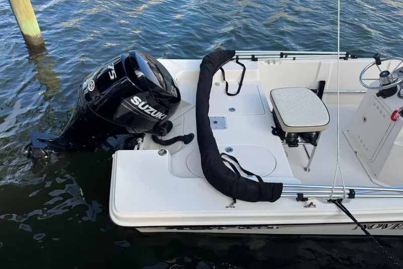 Slide: The Image of 2023 Carolina Skiff 16 JVX CC boat with Suzuki outboard motor on water. - 7