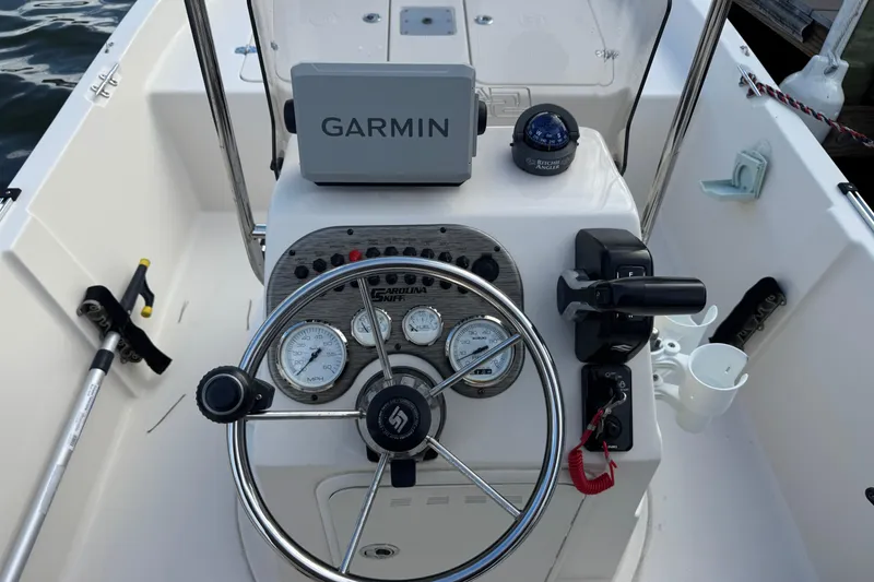 Slide: The Image of 2023 Carolina Skiff 16 JVX CC boat console with Garmin GPS and steering wheel. - 9