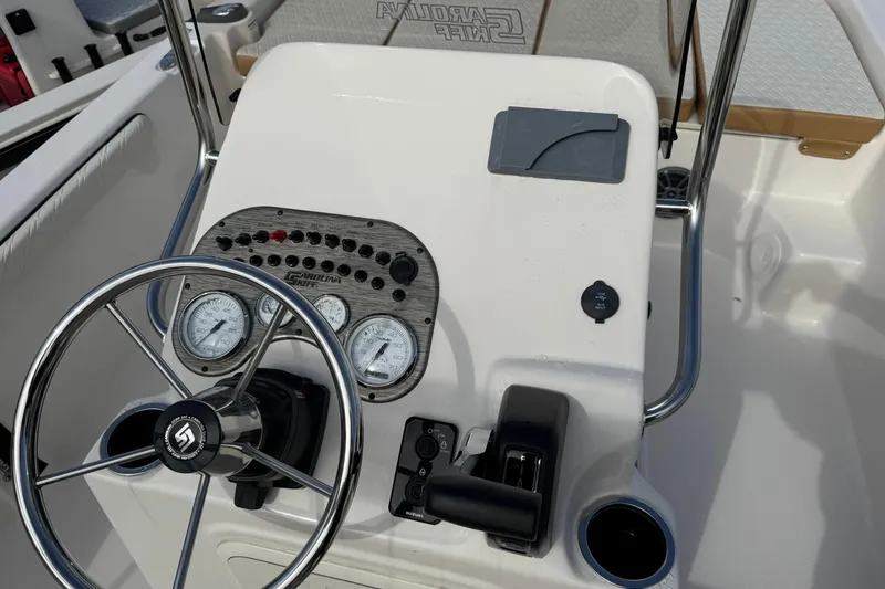 Slide: The Image of 2026 Carolina Skiff 19 LS boat console with steering wheel and gauges. - 12