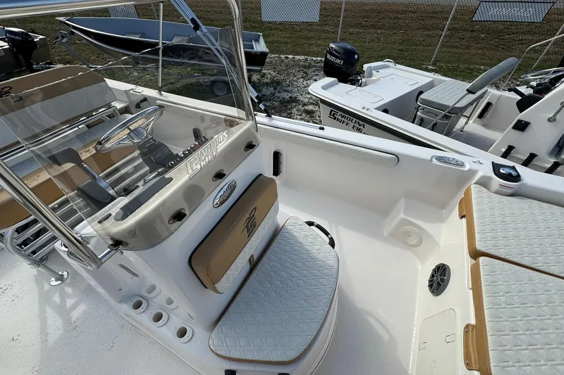 Slide: The Image of 2026 Carolina Skiff 19 LS boat interior with steering console and seating. - 17