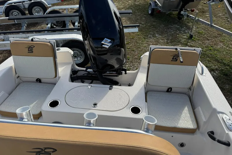 Slide: The Image of 2026 Carolina Skiff 19 LS boat interior with seating and motor, parked on a trailer. - 18