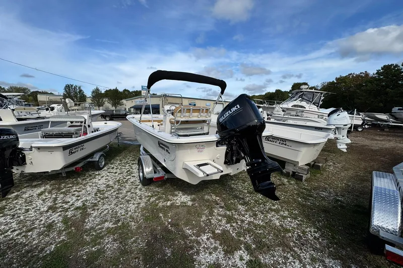 Slide: The Image of 2026 Carolina Skiff 19 LS boat with Suzuki outboard motor in a dealership lot. - 4