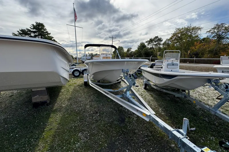 Slide: The Image of 2026 Carolina Skiff 19 LS boats on trailers, displayed outdoors under cloudy sky. - 8
