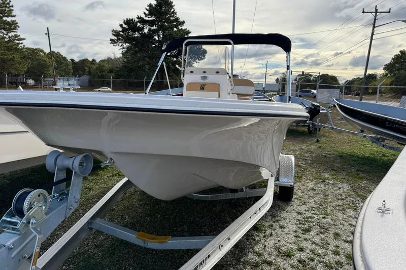 Slide: The Image of 2026 Carolina Skiff 19 LS boat on trailer, parked outdoors under cloudy sky. - 9
