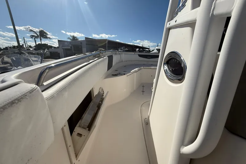 Slide: The Image of 2019 Robalo R242 Center Console boat interior with stainless steel railings and seating. - 15