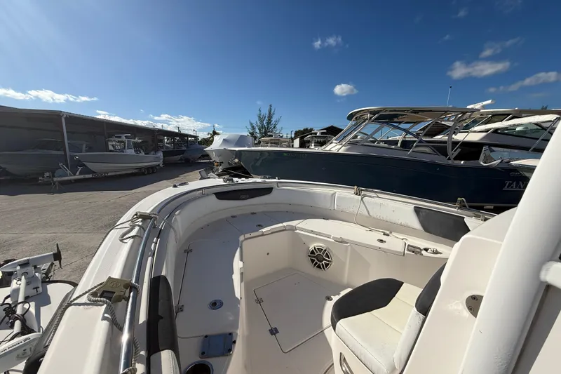 Slide: The Image of 2019 Robalo R242 Center Console boat docked under clear blue sky. - 16