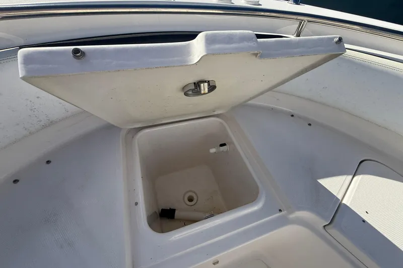 Slide: The Image of Open storage compartment on 2019 Robalo R242 Center Console boat. - 17