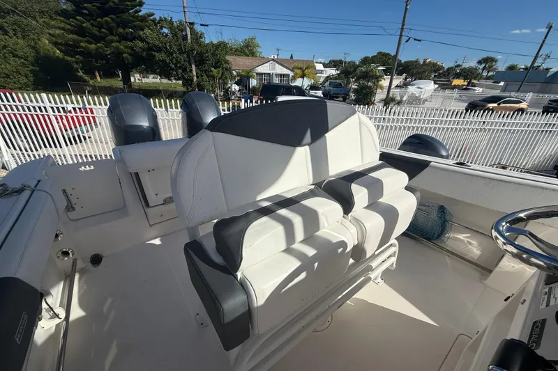 Slide: The Image of 2019 Robalo R242 Center Console boat interior with dual seats and steering wheel. - 19