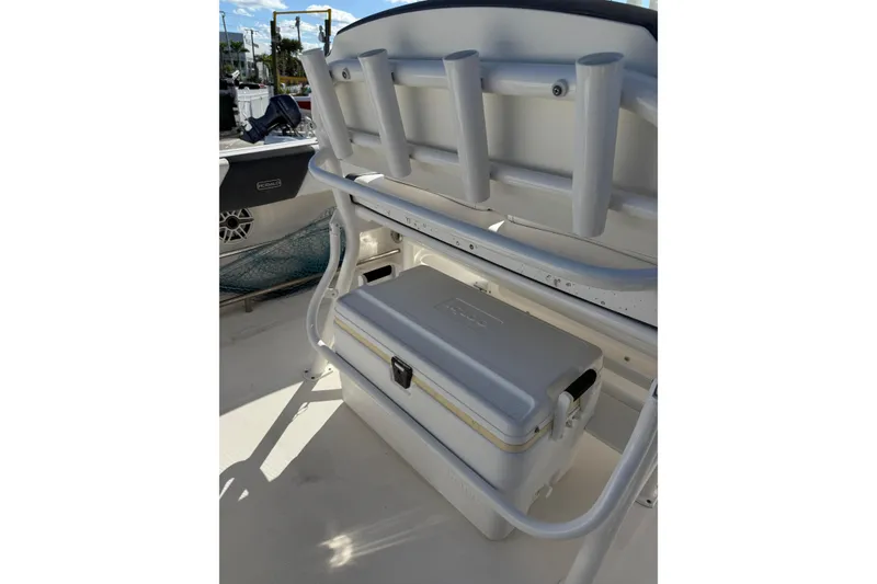 Slide: The Image of 2019 Robalo R242 Center Console boat interior with storage and rod holders. - 20